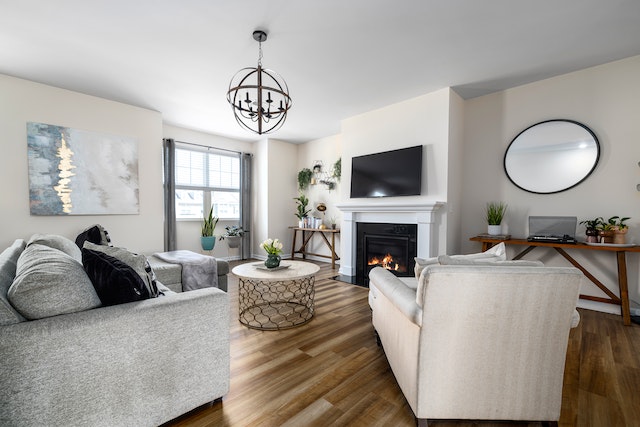 white living room with white furniture and a fire in the fireplace